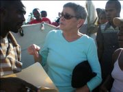 Anne Hastings, CEO of Fonkoze, talks to displaced Haitians about how to access emergency funds through Fonkoze.
