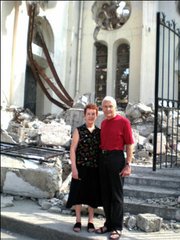 Mary and Gary Becker, residents of Santa Barbara and Board members of Fonkoze USA, in front of the destroyed catholic cathedral.