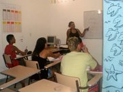 Students' repetition of written words is anything but tedious; it is necessary to introduce new sounds, like "r" and "th," that the average Carioca has never produced.