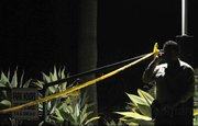 A sheriff's deputy maintains the crime scene perimeter following a fatal stabbing near Hendry's Beach on Thursday evening April 15, 2010