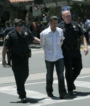 UCSB Professor William Robinson is taken into custody along with seven others intent on getting arrested to protest Arizona's State Bill 1070