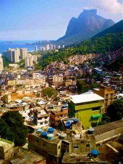 From the rooftop of a home in Rocinha, the community sprawls out in front, giving way to São Conrado in the flat area to the west, and the biggest seaside monolith in the world, Pedra de Gávea, in the background.