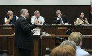 Detective Jaycee Hunter (foreground) speaks before the Fire and Police Commission Friday June 18, 2010
