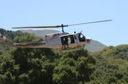 Helicopters, like the one seen here, were used to drop personnel into the field and haul out bundles of mature marijuana plants