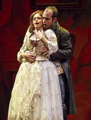 Zachary Altman as Don Giovanni interferes with Megan Hart as Donna Anna in the Music Academy’s production of <em>Don Giovanni</em>.