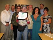 Santa Barbara MTD rider and Alpha Resource Center participant Dennis Subica (center) displays the “Imagine a World” award he presented to the Board and staff of MTD at a recent Board meeting. Accepting the award, from left, are Board Directors John Britton, Richard Weinberg, Alpha Director of Finance and Development Cory Woodruff, Chuck McQuarry, MTD Board Chair Dave Davis, Alpha Outreach Coordinator Marisa Pasquini, Brian Fahnestock and Olivia Rodriguez.