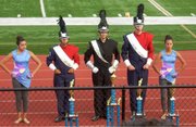San Marcos Band Members receiving trophies at the Valencia High School Marching Band Competition in Placentia: Guard Captain Justine Sanchez, Drum Captain Molly Richardson, Drum Major Preston Nunez, Drum Captain Jackson Foster, Guard Captain Jasmine Reyes.