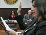 Helene Schneider and Grant House watch as City Clerk Cynthia M. Rodriguez swears in Randy Rowse to the City Council. Dec. 14, 2010