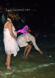 Some Brazilian woman make offerings to Iemanjá, female deity and protector of the oceans.