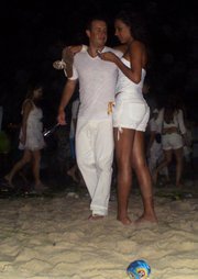 This couple adds to the sea of 2 million white-clad Réveillon celebrators on Copacabana Beach.