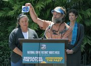 Jim (center) and Karen Boysel receive the Citizen of Courage Award for their work to promote safe and attentive driving following the death of their 12-year-old son Jake killed by a car while riding his bike to school.