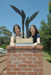 James Van Arsdale and Kimberly Hahn on their roof with Florian Morlat's tribute to the Dovers.