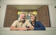Doug and Marian McKenzie at home in Montecito framed by a window curtained from Bettina Hubby’s “Hubby Moves In.”