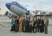 Local dignitaries, politicians and airport employees pose in front of a vintage DC-3 United "Mainliner" airplane at the Santa Barbara Airport remodel grand opening celebration June 17, 2011