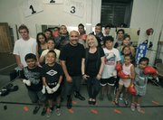 A small group working out at the Primo Boxing Club on a Monday afternoon step in the ring for a photo.