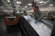 Flora Tuzaon and Eddie Admos carefully cull tomorrow’s delivery for “chunkies” — odd-sized letters.
