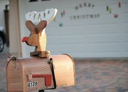 Neighbors on the 6100 block of Manzanillo Drive decorate their mailboxes with the same wooden reindeer head.