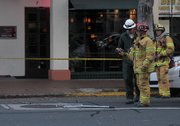 A Santa Barbara city fire captain uses a thermal imaging camera as crews respond to an underground electrical vault fire (April 5, 2012)