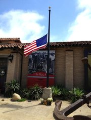The American flag in front of the Santa Barbara Historical Museum flies at half-mast after David Bisol's passing