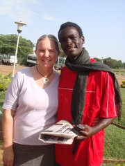 Davies Kabogoza and Vicky Harbison wait for a bus in Uganda on June 28, 2010.
