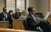 Sarah Taylor Swing (striped shirt) and Jennifer Taylor (black shirt, necklace) watch as Deputy District Attorney Brian Cota reads out charges