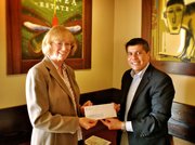 HTF President/CEO, Jennifer McGovern, receives a grant award from Rabobank Vice President of Community Development, Frank Bravo.