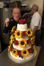 Confronted by wedding cake at Wayne Kjar Cakes, author D.J. Palladino bravely takes up his fork.