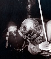Dan Wilson decompressing off the east end of Santa Cruz Island on November 3, 1962 during the ascent from his record breaking dive to 400' using oxy-helium as a breathing gas. The SCUBA diver in the background is one of several Brooks Institute students that acted as safety divers on the decompression stops.