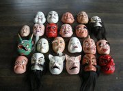 Kagura performers wear traditional hand-carved masks that, with their grotesque features, represent the Shinto divinities.