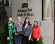 Meredith Tynes; Janet Garufis, President and CEO; Jamie Gilles; and Brianna Aguilar are presented with the traveling trophy.