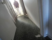 A Dario Pini tenant who has repeatedly asked for new paint and carpeting. This patch in the hallway appears to not only be worn but also without padding, and the carpet looks like it had been previously installed at a different location. (Dec. 12, 2012)