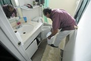 A Dario Pini tenant says he empties a wastebasket full of water twice a day from a leak under the sink. (Dec. 12, 2012)