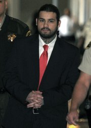 Adrian Robles leaves the courtroom after a jury found him guilty of first-degree murder in the 2010 stabbing death of Robert Simpson
