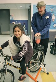 Erik Talkin, CEO of the Foodbank of Santa Barbara County, helps 7-year-old Yvonne Govea with a bicycle-powered blend at Isla Vista Elementary School as part of the Santa Barbara County Healthy School Pantry program.