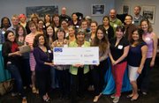 Representatives from the various participating departments at the campaign celebration party with a donation check.
