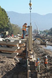 <b>MEN AT WORK:</b> Construction crews work on the San Jose Creek channel along Highway 217.