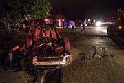 A Subaru Outback rests upside down after colliding with a Ford Escape carrying two police officers