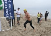 <b>LAND HO:</b> Nineteen-year-old Naval Academy midshipman Riley Mita (pictured right) was the fi rst racer out of the water, winning the Reef & Run mile ocean swim with a time of 21 minutes and two seconds.