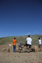 <b>WEEKEND GETAWAY:</b> (from left) Luis Arias fires downrange as Javier Rios and Fabian Iniguez look on at the Arroyo Burro “Glass Factory” shooting range.