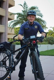 Corporal Matt Stern, of the UCSB Police Department, takes a break from his bike patrol on campus.
