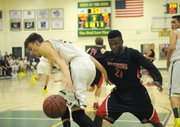 <b>HOOP SPIRIT:</b> This year's Holiday Classic saw Santa Barbara High and Carpinteria High go head-to-head. Pictured above, 6'5" Don Jack Baker (left) keeps the ball out of reach from Warrior defender Bryson Frazer (right), the fastest player on the floor.
