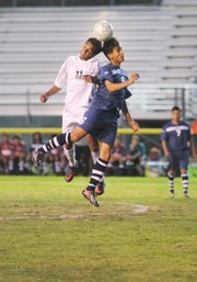 <b>HEAD-TO-HEAD:</b> Brandon Sanchez (11) of the Dons went up for the ball with Newport Harbor’s David Mondragon (6) at Peabody Stadium on Thursday in the opening round of the CIF Southern Section Division 1 soccer play-offs.