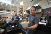 Empty Bowl Gourmet Noodle Bar co-owner Jerry Lee, with a bowl of northern Thai curry noodles.