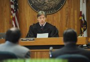 Judge James Voysey (center) accepts guilty pleas from Raymond Morua (right) with attorney Darryl Genis