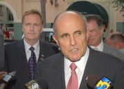 David Lack (left) stands behind then presidential candidate Rudy Giuliani (Sept. 27. 2007)