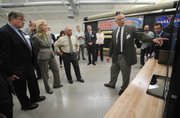 Deployable Space Systems president Brian Spence briefs NASA Administrator Charles Bolden and Congressmember Lois Capps on his company's Roll-Out Solar Array