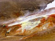 Fumaroles — openings in a planet's crust, often near volcanoes — show abundant sulphur (yellow) being emitted. UCSB students wearing hard hats and safety vests show scale.