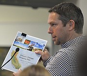Ben Oakley of ERG holds a state scoping report on the climate change plan as he speaks to Santa Barbara County planning commissioners during public comment on the greenhouse-gas emissions threshold issue Thursday morning in Santa Maria.