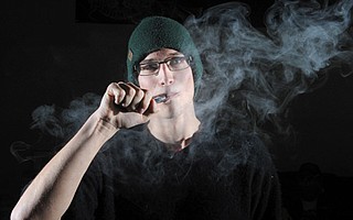 Collin Walker at Santa Barbara Vapor puffs away at his e-cigarette.