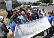 A coalition of farmworkers, activists, government and religious community members gather Friday outside the newly built ICE facility in Santa Maria.